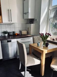 a kitchen with a wooden table with chairs and a table and a table at Stadtwohnung Mettmann in Mettmann
