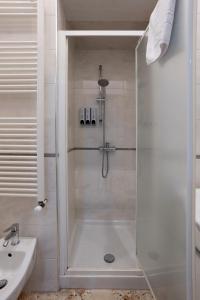 a shower with a glass door in a bathroom at A Casa di Paola B&B Lecce in Lecce