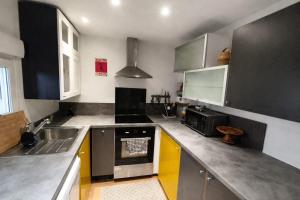 a kitchen with a sink and a stove at Garden Lodge Formiguères in Formiguères +7 photos