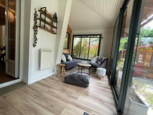a living room with a couch and a table at Garden Lodge Formiguères in Formiguères