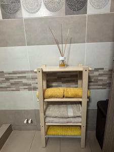 a shelf with towels on it in a bathroom at Sunny Apartment in Constanţa +18 photos