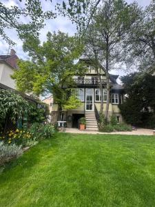 a large house with a lawn in front of it at studio 50m2 au bord de l'eau à STRASBOURG in Strasbourg