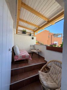 a patio with a table and chairs on a balcony at Apartments Rome in Baška