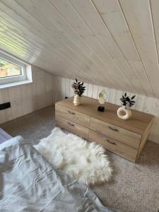 a room with a bed and a dresser in a attic at Domeček pod lípou in Neveklov