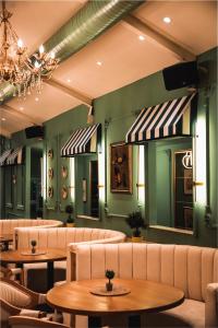 ein Restaurant mit Sofas, Tischen und Spiegeln in der Unterkunft Hotel Diwa in Tetovo