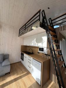 a small kitchen with a bunk bed and a staircase at Domeček pod lípou in Neveklov