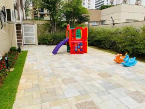 a playground in a yard with toys on it at Flat Vila Olimpia Hotel Experience in São Paulo