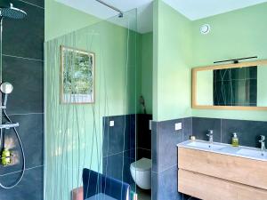 a bathroom with a shower and a sink and a toilet at Le Petit Jard'Inn in Chalons en Champagne +31 photos