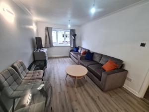 a living room with a couch and a table at Mailbox and Broad St in Birmingham +2 photos