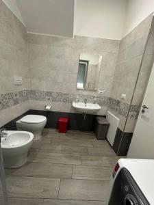 a bathroom with a toilet and a sink and a mirror at Mazzini Home in Cosenza +12 photos