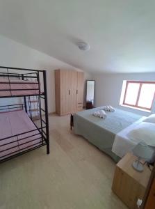 a bedroom with a bunk bed and a bunk bed at L'Imperiale Granaio Casa Vacanze in Rocca Imperiale