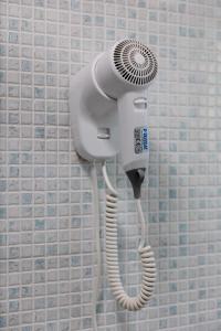 a blow dryer on a wall in a bathroom at A Casa di Paola B&B Lecce in Lecce