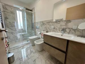a bathroom with a sink and a toilet and a shower at Il Colle in Sanremo