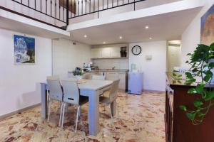 a kitchen with a table and chairs and a refrigerator at A Casa di Paola B&B Lecce in Lecce