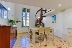 a dining room with a table and chairs and a staircase at A Casa di Paola B&B Lecce in Lecce +34 photos