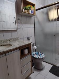 a small bathroom with a toilet and a sink at Hospedaria AlpenGlück in Treze Tílias +14 photos