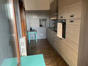 a kitchen with a counter and a blue table at Casa Vacanze Leno in Leno