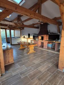 a large room with a table and a brick oven at Cabana NEST in Bistricioara