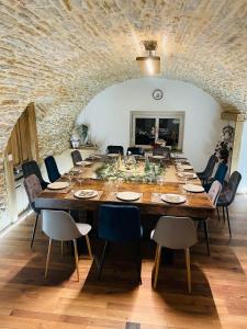 a large dining room with a long table and chairs at La Parenthèse in Vitreux