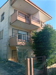a building with balconies on the side of it at Penelope apartment in Neoi Epivates