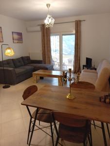 a living room with a table and a couch at Penelope apartment in Neoi Epivates