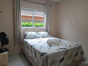 a bed in a bedroom with a window at yes banana in Bananeiras +31 photos
