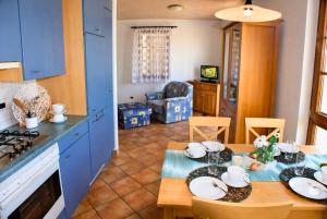 eine Küche und ein Esszimmer mit einem Tisch, auf dem Geschirr steht in der Unterkunft Case Bellissime in Tronzano Lago Maggiore