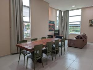 a dining room with a wooden table and chairs at yes banana in Bananeiras