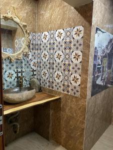 a bathroom with a sink and a mirror at Nhà Bên Suối Retreat in Làng Tè +25 photos