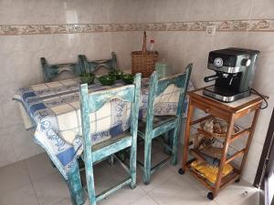 a kitchen with a table with a coffee maker on a table at Minha Alegre Casinha in Sines