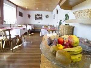 a bowl of fruit on a table in a restaurant at Gasthaus Schweizerhof in Titisee-Neustadt