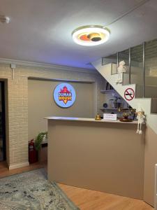 a kitchen with a counter and a sign on the wall at Duman House in Almaty