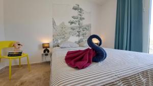 a bedroom with a bed with two swans on it at Azot Villa in Le Tampon +21 photos