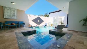 a swimming pool in the middle of a room at Azot Villa in Le Tampon
