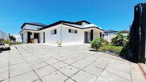 a white house with a black roof at Azot Villa in Le Tampon