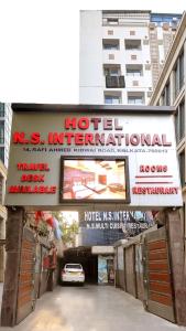 a sign for a hotel international journal in a city at N S International in Kolkata