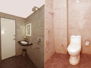 a bathroom with a toilet and a shower and a sink at N S International in Kolkata +30 photos