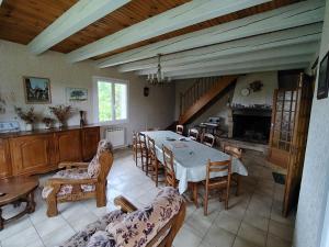 a large living room with a table and chairs at VIDAL BERNARD in Saint-André-de-Vézines