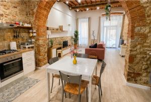a kitchen and living room with a white table and chairs at La Casina del Corso in Massa Marittima