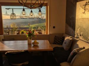 a living room with a table and a couch at Bergchalet mit Pool und Sauna, ganz nah am Bikepark Weitnau, direkt am Skilift in Missen-Wilhams