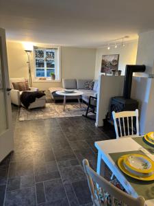 a living room with a couch and a table at Strand huset in Hitra