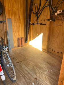 a room with a bike parked in a wooden building at Ferienwohnung Charly in Carolinensiel