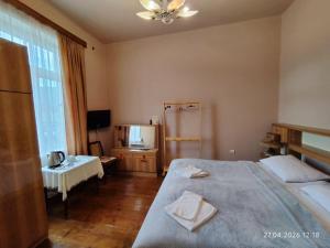 a hotel room with a bed and a television at MariElla in Akhaltsikhe