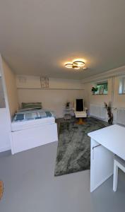 a living room with a bed and a couch at Gästezimmer am Deister in Barsinghausen