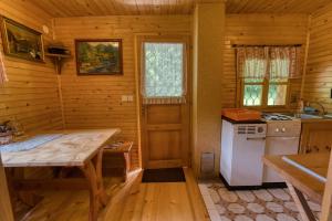 a kitchen with a table in a wooden cabin at Princess Vogar in Bohinj