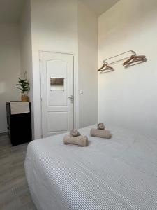 a bedroom with a bed with two towels on it at L'Aile de Fontainebleau in Fontainebleau