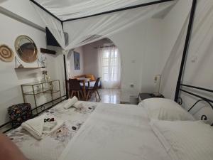 a bedroom with a large bed and a table at Aegeon Pension in Aegiali