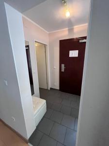 a bathroom with a toilet and a door at Urban City Nest in Vienna