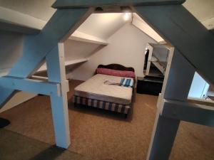 a small bedroom with a bed in a attic at VIDAL BERNARD in Saint-André-de-Vézines