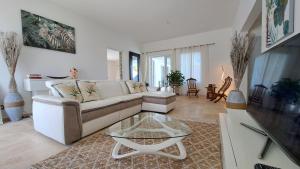a living room with a couch and a coffee table at Azot Villa in Le Tampon